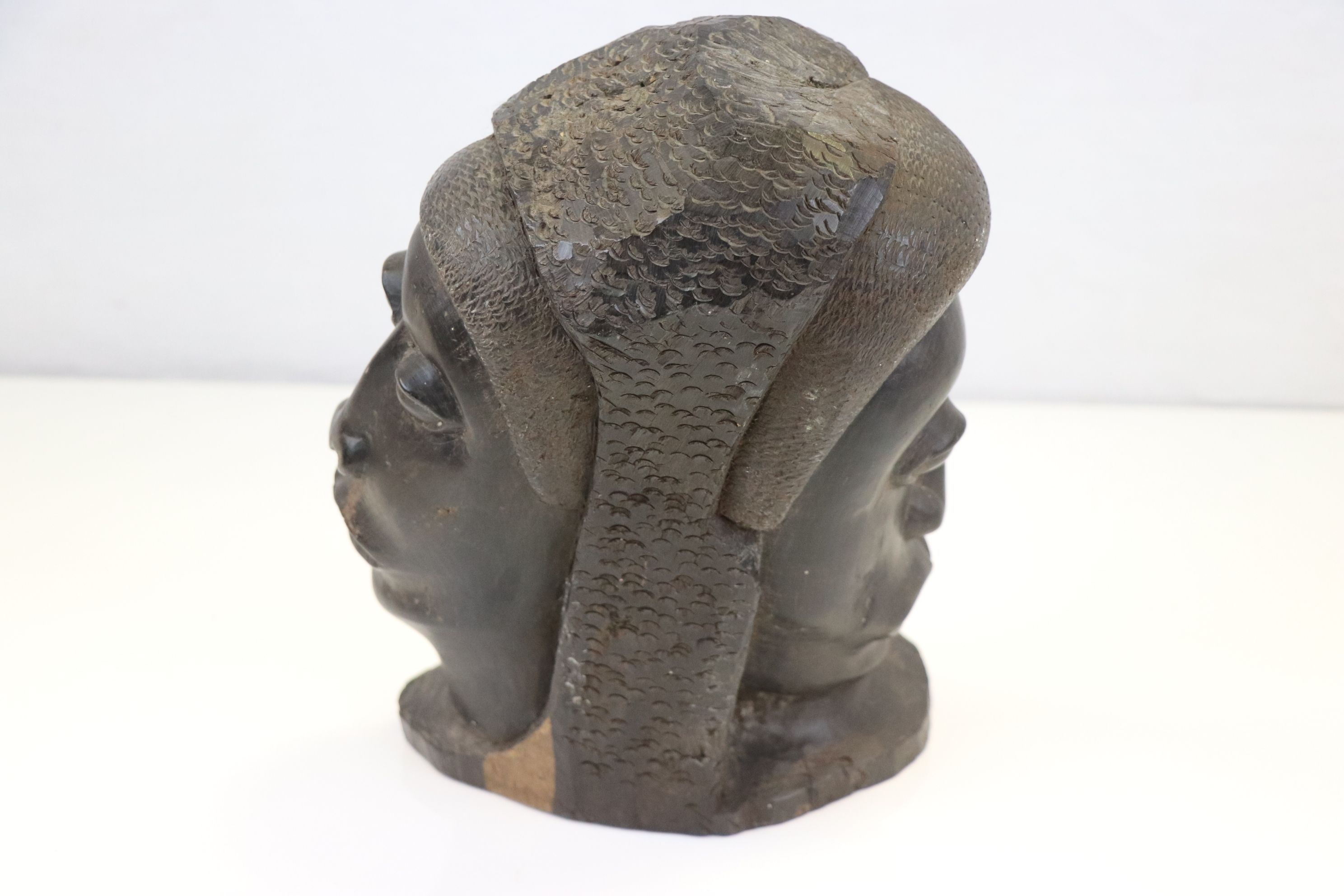 A tribal carved two-faced hardwood bust sculpture of African men