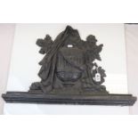Cast Iron Plaque in the form of a Lidded Urn swagged in cloth and surrounded by flowers, 63cms x