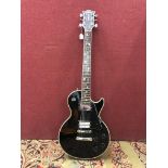 Guitar - Aria Pro II Custom Les Paul style electric guitar in black, contained within a hard case