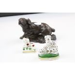 A resin figure of a spaniel dog and two small stafffordshire style dog figures
