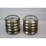 A set of 10 x glass coasters with white metal rims, rims marked Rank M. Whiting & Co, Sterling.
