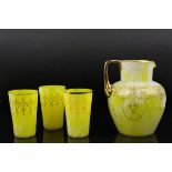 An antique yellow ground glass jug with scrolling gilt to decoration together with tgree similar