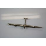A white metal brooch in the form of a glider