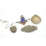 Tobacco tin containing a Victorian silver "Delia" brooch, HMS Queen Mary bar brooch and a silver