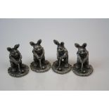 Set of four miniature figures in the form of rabbits playing golf.