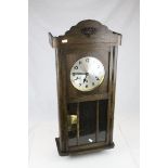 An early 20th century oak cased three train movement Vienna style wall clock.
