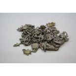 Collection of white metal and silver charms,