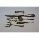 Small collection of silver and silver plated items to include sugar tongs and sugar sifter.