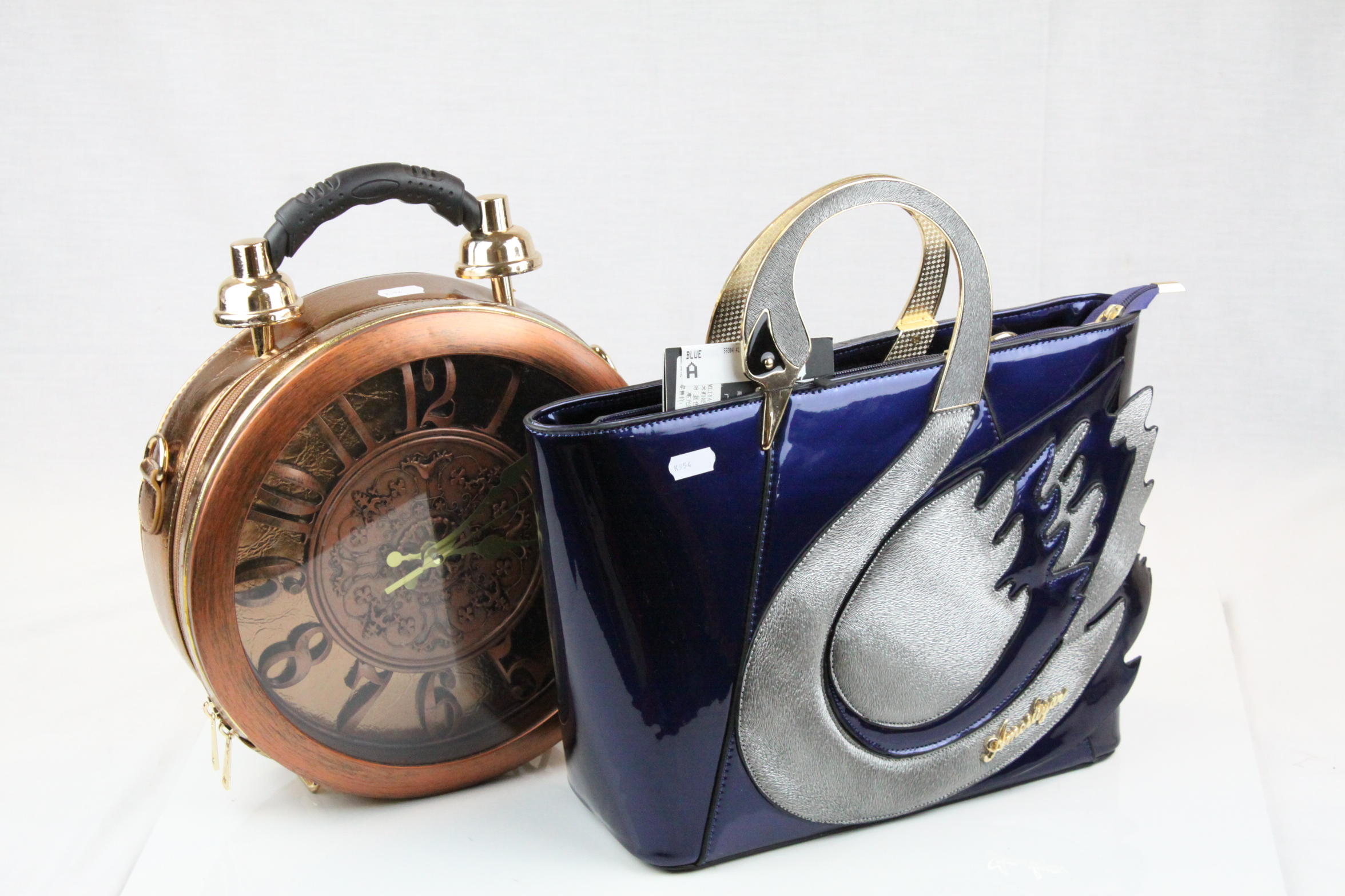 Two Handbags - Ameiliyar Swan Handbag, 36cms wide together with a Battery Operated Clock Handbag,