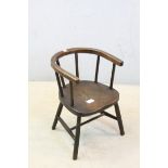 A late 19th century elm seated childs elbow chair