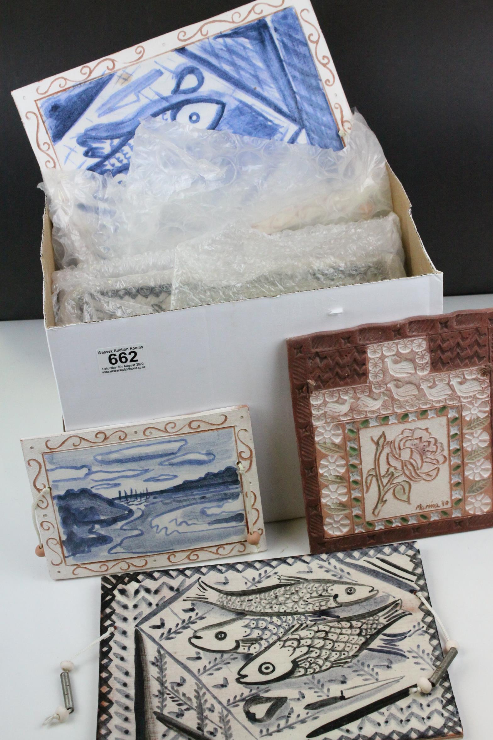 A quantity of late 20th century teracotta decorated tiles.