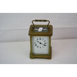 Antique French made brass cased carriage clock with white enamel dial complete with key.