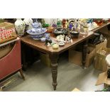 Late Victorian Mahogany Wind-Out Dining Table raised on turned ringed legs and terminating in