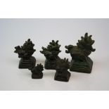 Set of five Chinese metal opium weights in the form of Foo Dogs (Chinese Guardian Lions).