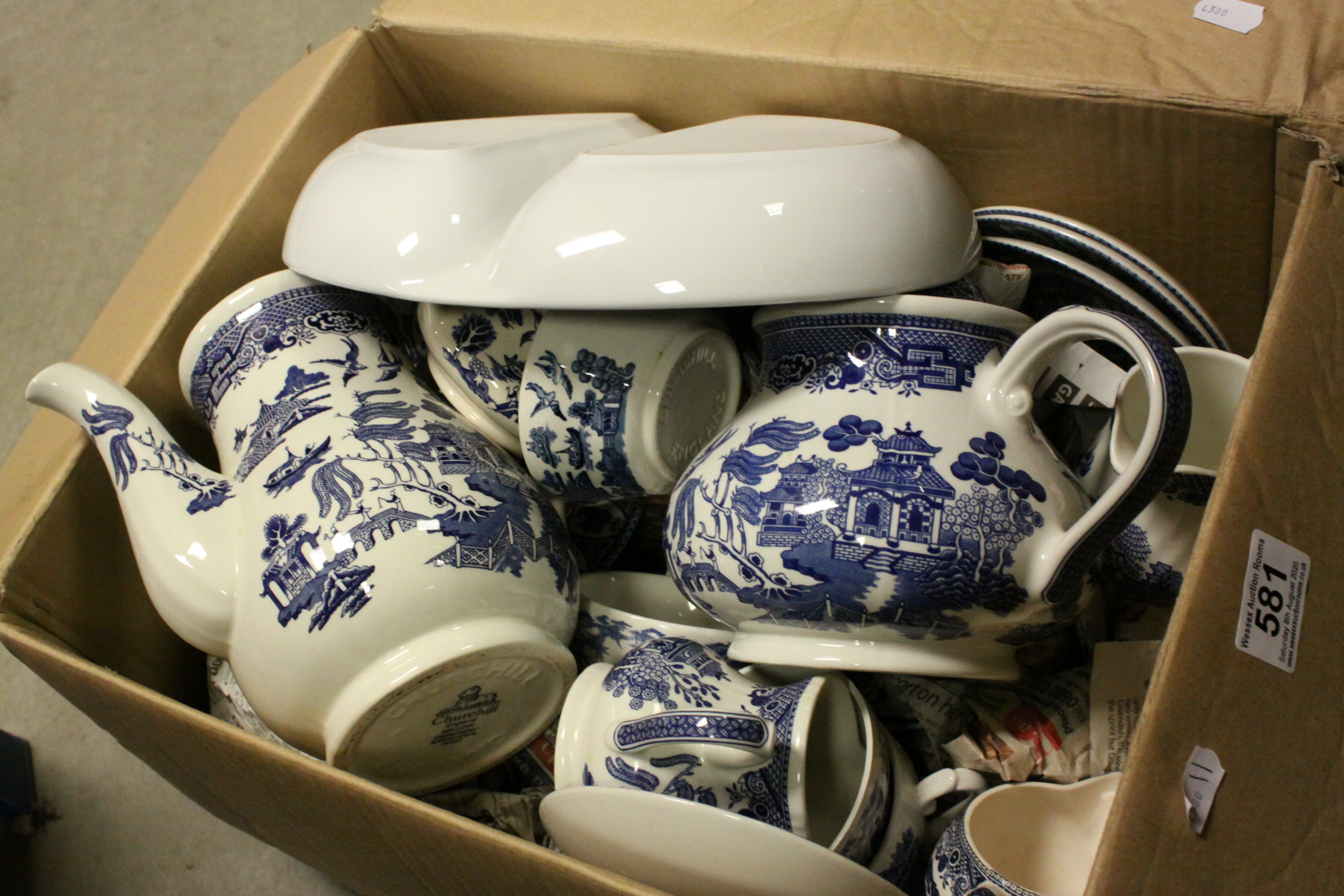 A large quantity of blue and white china to include willow pattern etc.