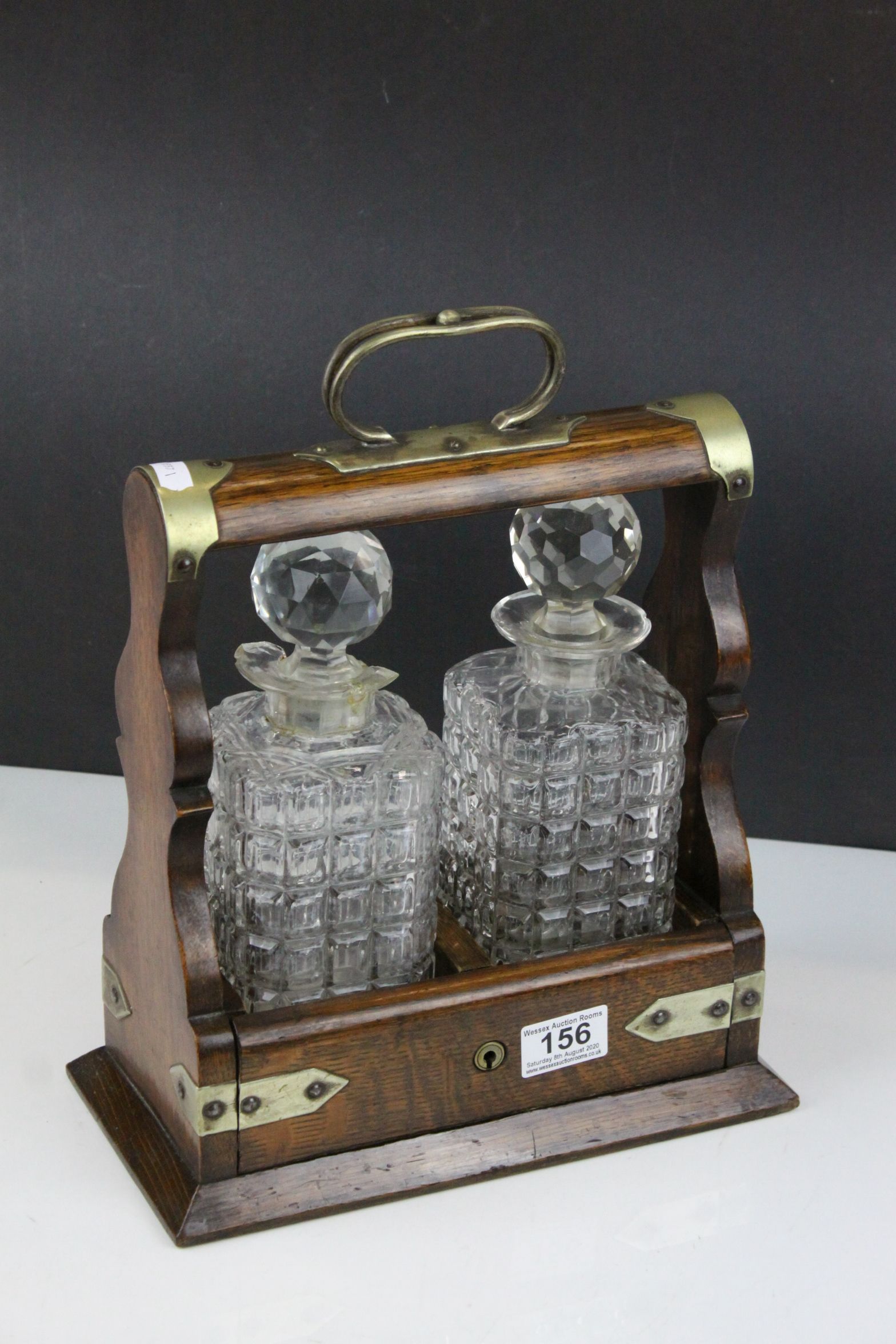 Late 19th / Early 20th century Oak Two Bottle Tantalus with Silver Plated Mounts (matching decanters