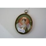 An early 19th century miniature portrait of a lady mounted in a later frame.