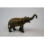 A brass/bronze figure of an elephant