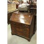 George III Mahogany Bureau with four long drawers raised on bracket feet (some losses and