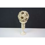 Antique decoratively carved ivory puzzle ball on stand. Stands approx 22cm on stand.