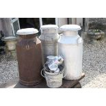Two Galvanised Milk Churns and another Milk Churn, 72cms high together with Three Small Milk