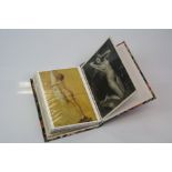 Small collection of erotic postcards contained within an album.