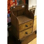 A vintage rustic pine two-drawer hanging cabinet