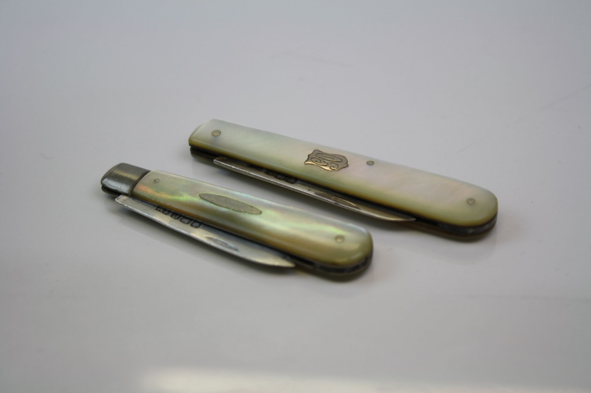 Two fully hallmarked sterling silver & mother of pearl folding fruit knives.