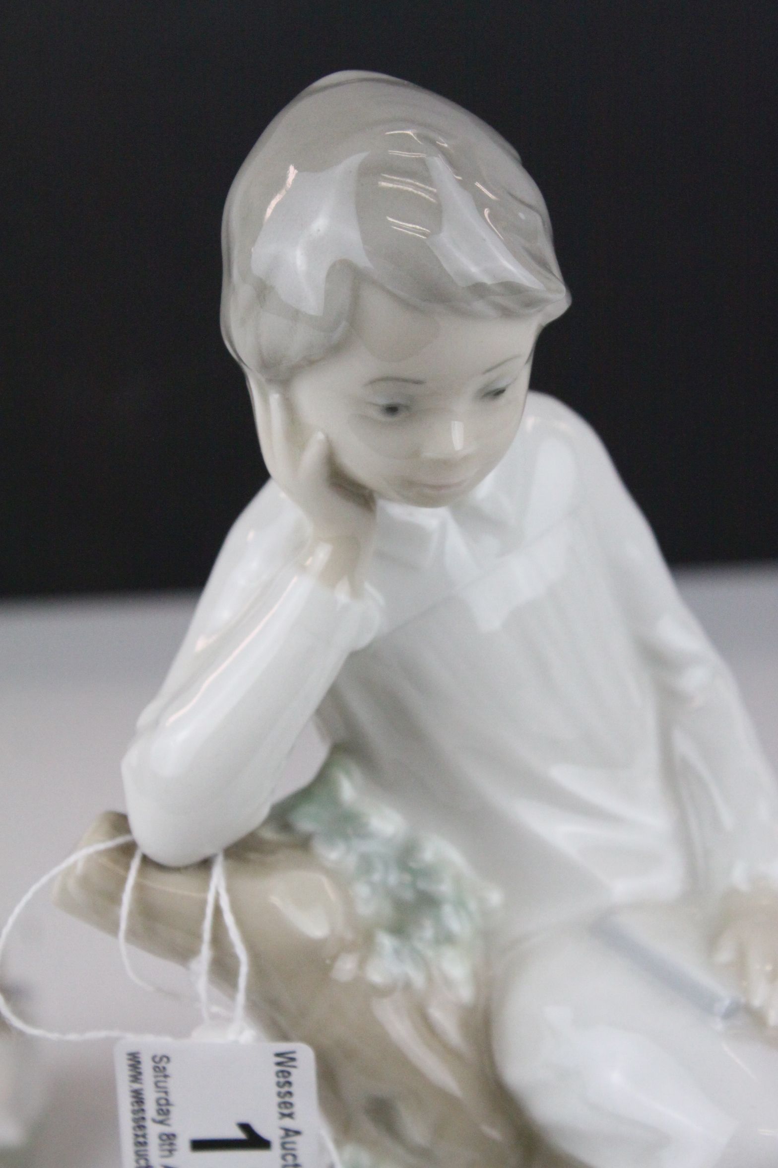 Two Lladro Figures - Boy with Book sat on a Tree, 21cms high and Baby sleeping on a Pillow, 10cms - Image 8 of 9