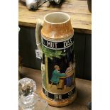 A large 20th century ceramic German Stein decorated with figures in a bar / inn.