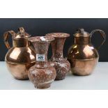 A pair of copper Guernsey milk canisters and a pair of stone marble vases.