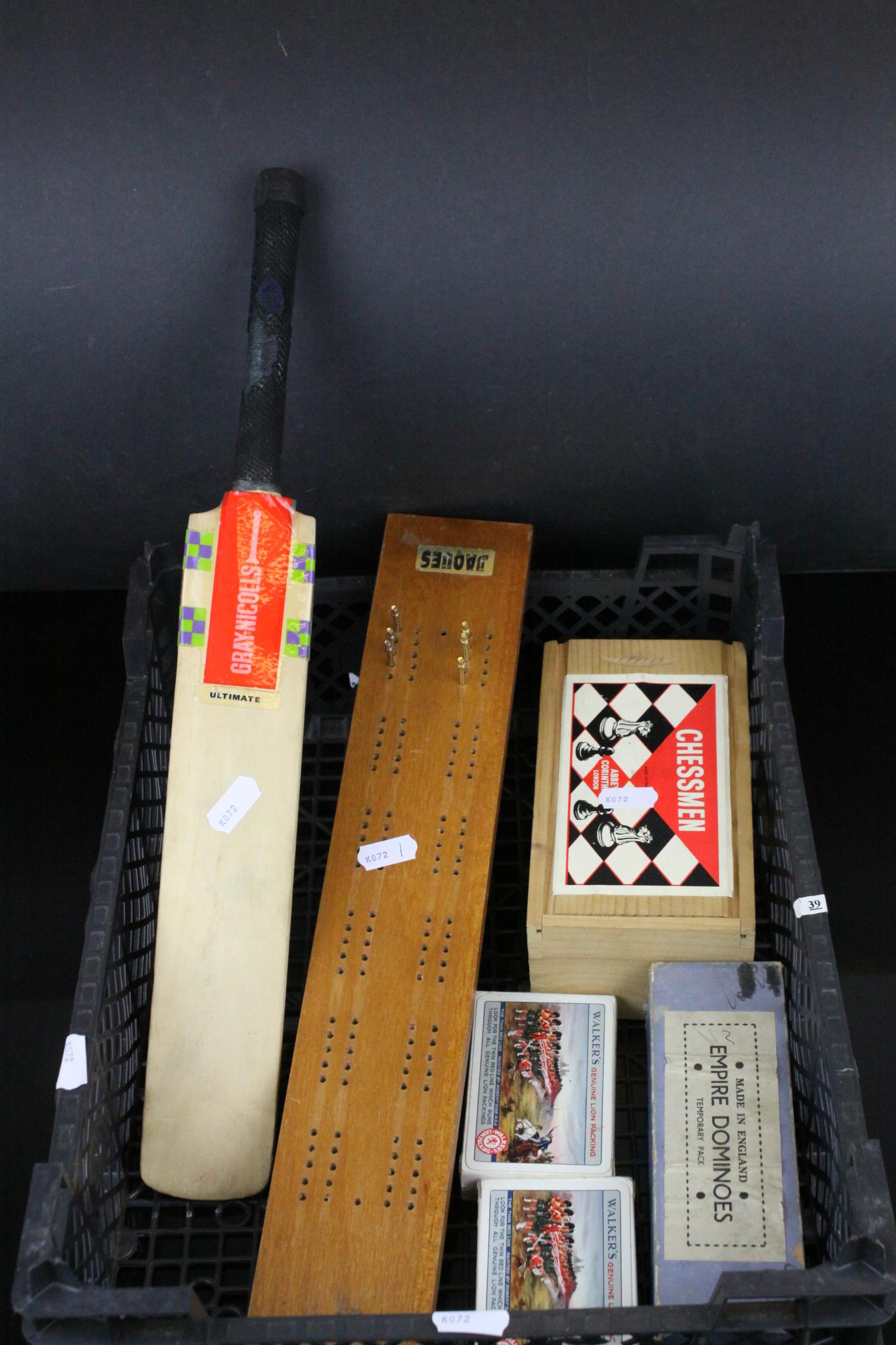 A group of items to include miniature cricket bat ,cribbage board and cards domonoes set and