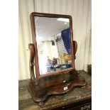Victorian Mahogany Swing Mirror, the shaped base raised on four ball feet, 54cms wide
