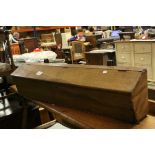 A vintage fruitwood long box with iron hangers, possibly from a cart