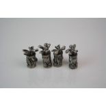 Set of four miniature pewter golf bags.