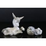 Two Lladro Figures - Donkey with Daisy, 17cms long and Duck with Ducklings in a Basket, 10cms long