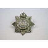 A White Metal Cap Badge To The 5th Volunteer Battalion Of The Devonshire Regiment With Kings Crown