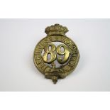 A Victorian 89th Regiment Of Foot Princess Victoria's Regiment Brass Cap Badge, With Twin Loop
