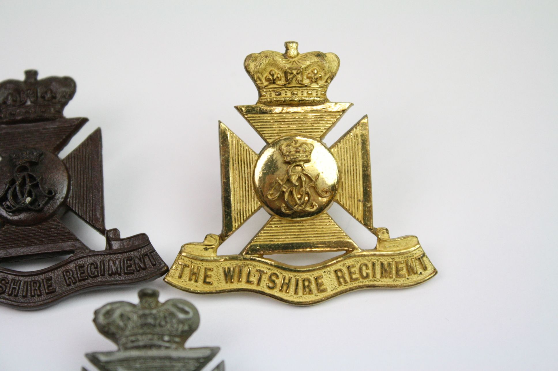 A Collection Of Seven The Wiltshire Regiment Cap Badges To Include A Bronzed, Brass, White Metal, - Image 6 of 14