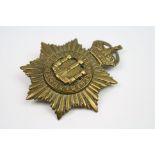 A Brass Band Badge To The Devonshire Regiment With Kings Crown And Twin Loop Fixings To The Rear.