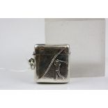A silver vesta case embossed with golfer image