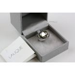 A silver Lalique ring in box with papers