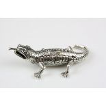 A silver figure of a reptile