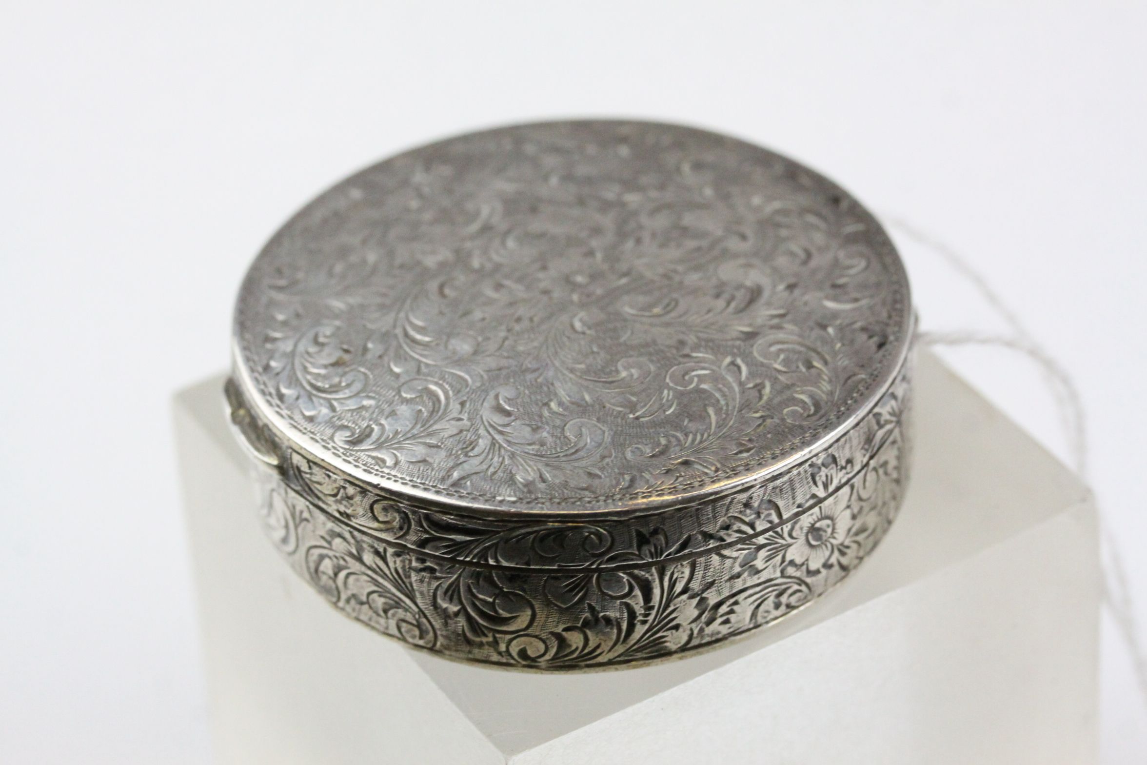 A hallmarked French silver patch box with mirrored lid, approx 5cm diameter.