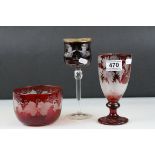 A bohemian etched ruby goblet with deer and floral decoration a similar bowl with grapes and vine