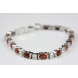 A silver line bracelet set with goldstone and CZ's