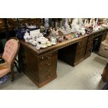 Early 20th century Oak Twin Pedestal Desk with Brown Leather Inset Top over an arrangement of