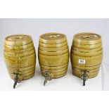 Three Stoneware Salt Glazed Spirit Barrels with Taps, h.24cms