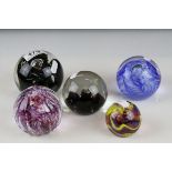 Five glass paperweights Caithness Dragonfly,Mischief,Moon crystal,Optix and one other.