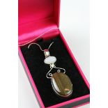 A silver Tigers eye style pendant necklace